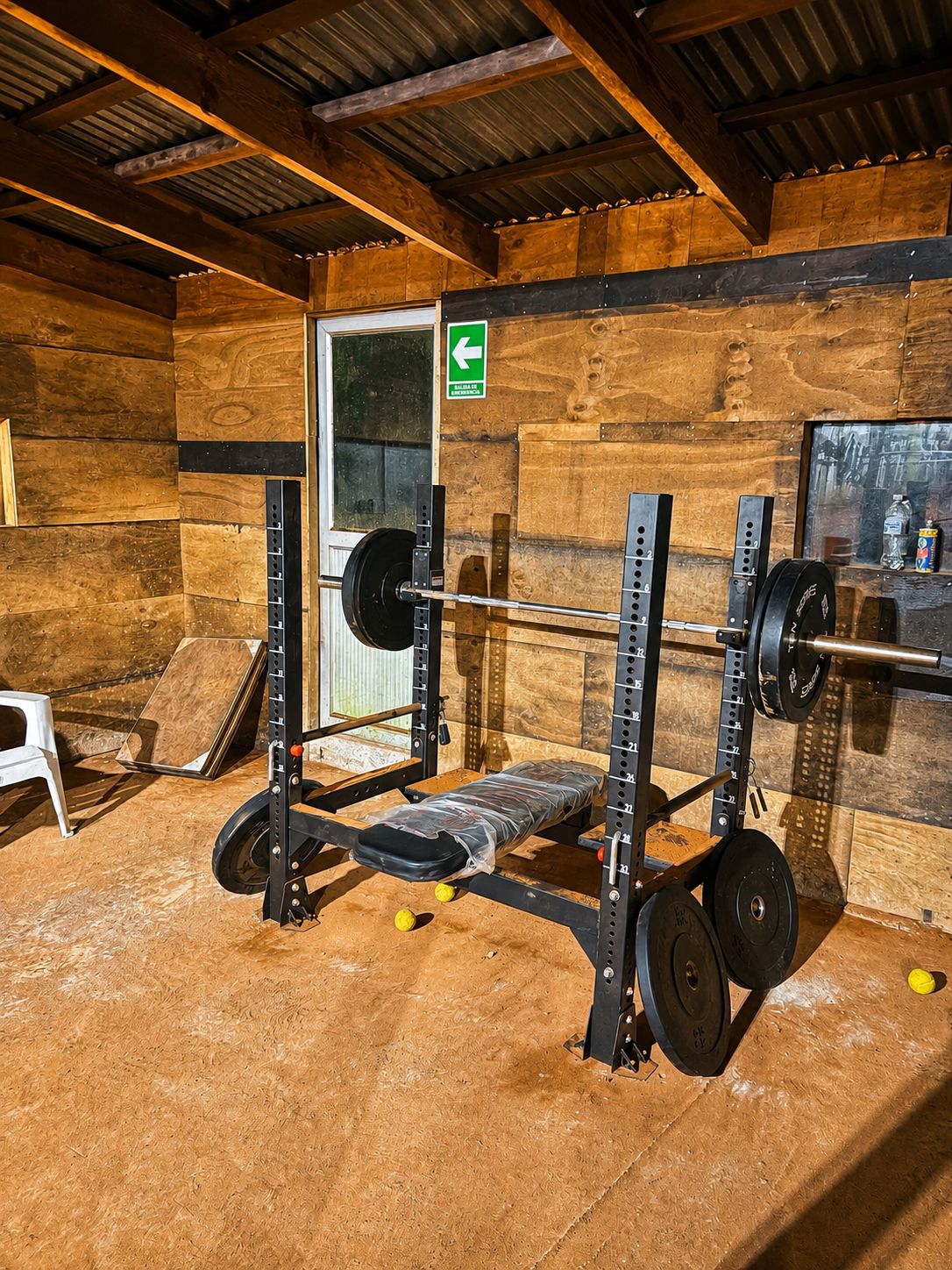 Banca y barra con discos en el gimnasio